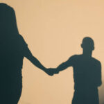 Couple holding hands on a walk showing signs your relationship will last