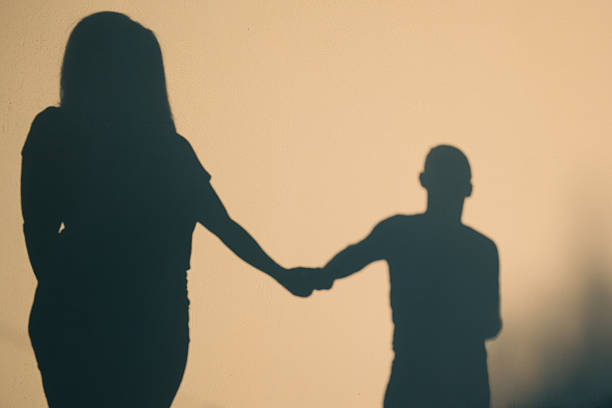 Couple holding hands on a walk showing signs your relationship will last