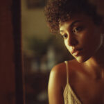 Self-love and healthy relationships concept showing a young adult looking into a mirror while their reflection appears more confident, symbolizing self-growth and emotional healing.